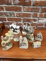 Nine resin cottage figurines on tabletop