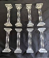 Six knife rests upright showing twisted columns and square bases