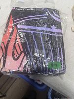 Sealed package showing folded comforter with abstract pattern, green sticker H41 visible