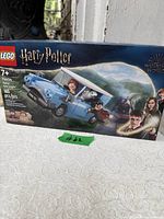 Front of sealed LEGO Harry Potter set 76424 box showing car and minifigures, age and piece count