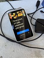 Front of Square terminal displaying startup screen