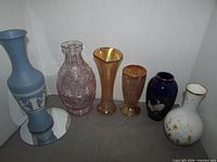 Group shot showing all six vases side by side for scale, colours and styles