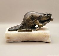 Front view of bronze beaver on marble base