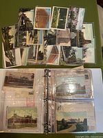 Binder open showing sleeved postcards and loose cards displayed