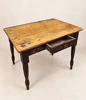 Overall view of table showing honey wood top and dark legs