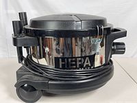 Full view of canister vacuum on wheels