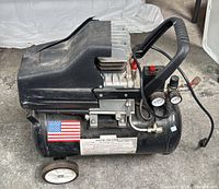 Side view of Central Pneumatic air compressor showing full unit, wheels, handle and tank