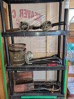 Shelf view showing both reels, fish basket, ladles, tackle box, rope