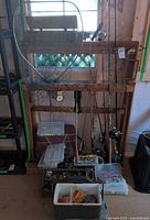 Overall view of rack, rods, net, tackle boxes and tote