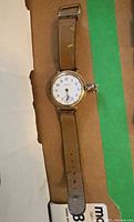 Front view of Waltham wristwatch showing dial, band, missing crystal