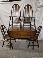 set displayed with two chairs on tabletop and two on floor