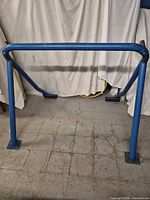 Front view of blue steel roll bar standing on floor
