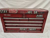 Front view of red Craftsman top tool chest with drawers and decals