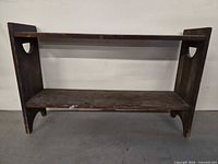 front view of two-tier wooden shelf showing overall structure