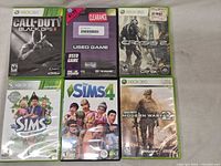 Front view showing six Xbox 360 game cases and sleeve