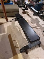 Top view of bench showing black padded surface and steel end brackets