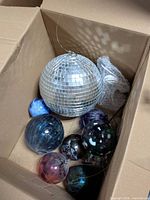 Box containing mirrored disco ball and assorted coloured glass balls