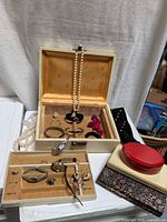 Overall lot showing ivory jewelry box open with contents, watches in tray, loose pearl necklace, black studded case and stacked empty cases