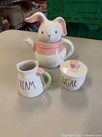 Front view of bunny teapot, creamer, sugar bowl with lids displayed