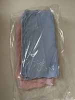 Blue and pink napkins bundled in plastic