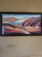Full view of framed landscape print on wall