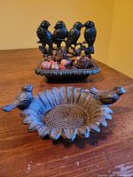 Both cast iron bird motif dishes grouped