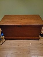 Closed wooden blanket box front view