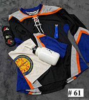 All items: jersey, water bottle, skate towel, sharpener, four pucks