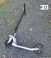 Scooter unfolded showing frame, wheels, and handlebars