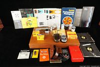 Overall view of all exposure meters, filters, film boxes, batteries and manuals on display