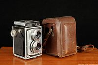Front view of Firstflex camera and leather case