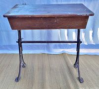 Front view of desk showing wood box and cast iron legs