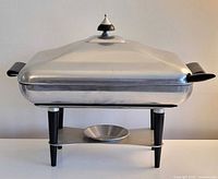 Front view assembled showing dish, lid, stand
