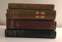 Stack of four vintage hardcover books showing spine titles