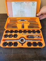 set in orange case showing dies, taps, handles