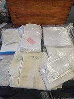 Overview of assorted folded linens in plastic sleeves and bags