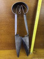 Full view of sheep shears beside measuring tape showing length