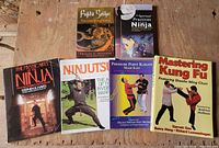 All six martial-arts books laid out on tabletop showing fronts