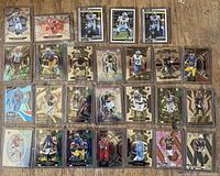 full lot shot of 26 sleeved cards on wood surface