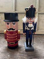 Front view of both nutcracker and tin