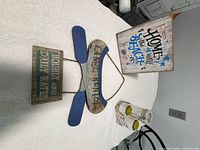 Group view of both signs and three-piece candle holder set