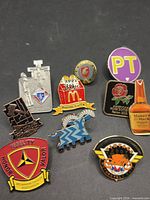 All ten lapel pins on black background
