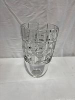 Full view of crystal vase showing geometric grid pattern and smooth base