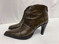 Left side view of both boots showing color, perforation, pointed toe, heel