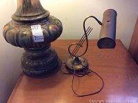 Large vintage table lamp base close-up showing ornate sculpted design and label with dimensions