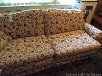 Sofa with floral upholstery showing cushioned seats and backrests