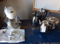 Wide view of the kitchen items including stand mixer, coffee percolators, electric kettle, and chafing dish