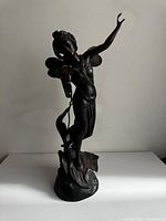 Full view of bronze winged female statue on base