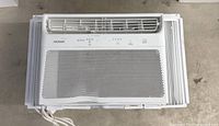 Front view of Noma window air conditioner showing grille and control panel