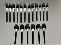 Full view showing 17 forks and 6 spoons